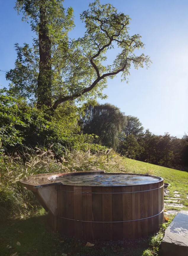a classic and simple wooden tub surrounded with greenery is the perfect place to enjoy the scenery around