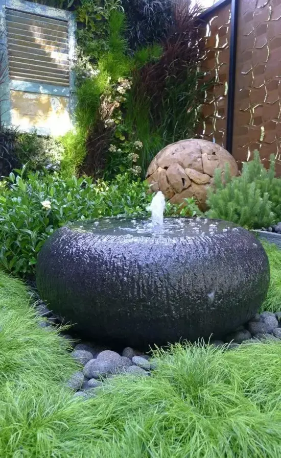 a creative and ultra-minimalist black bowl fountain is a lovely idea for a modern, minimalist or zen-like garden