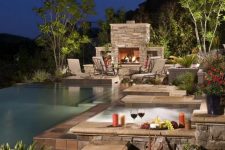 a hot tub combined with a fireplace and a pool would make any outdoor place trully awesome