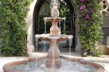 a large tiered stone fountain is a very elegant and chic space, it will give that refined Spanish colonial feel to the garden