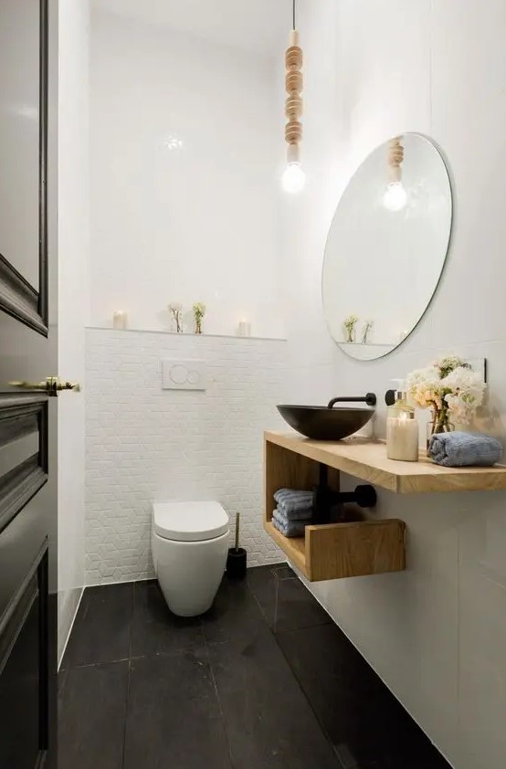 a modern meets Scandinavian powder room with a creative wooden geometric vanity with a metal sink and towel storage