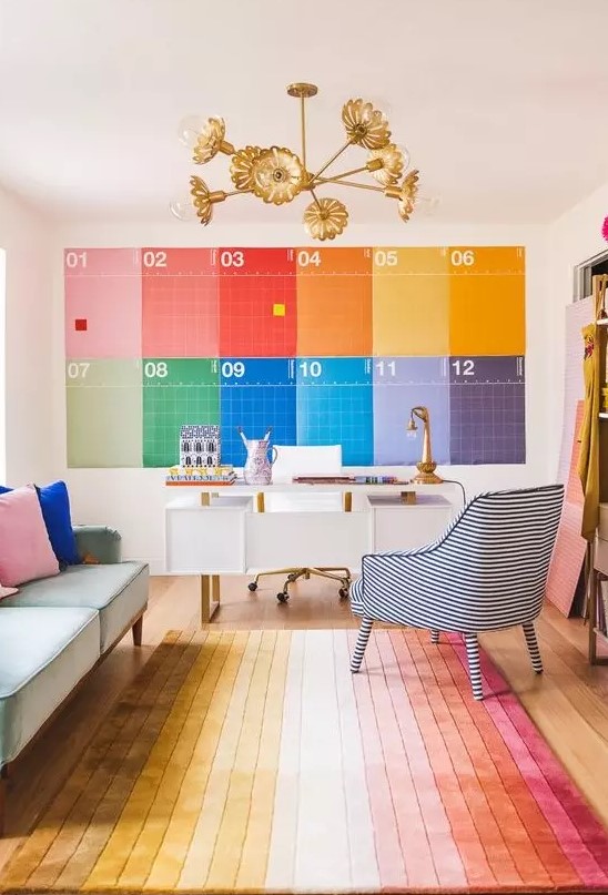 a rainbow home office done with all the colors of the rainbow, with a white desk, a pastel sofa and a striped chair just wows