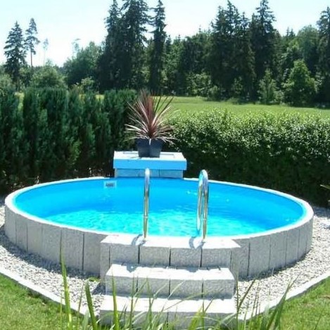 a raised round pool clad with stone and accented with a single statement plant opposite the stairscase