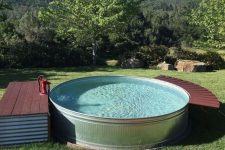 a round tank pool with a small deck with storage and another curved piece to relax on can be DIYed