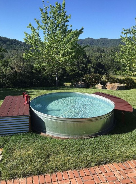 a round tank pool with a small deck with storage and another curved piece to relax on can be DIYed