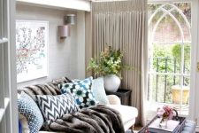 a she shed decorated as a cozy and elegant living room, with soft textiles and faux fur