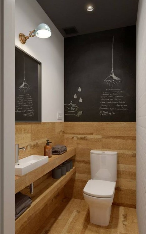 a small contemporary powder room with wood-inspired tiles and chalkboard, a vanity with open shelves and lights