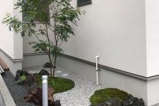 a small front yard Japanese garden with greenery, rocks and pebbles and a single tree is a cool idea to make your entrance more natural