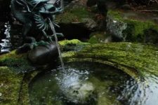 a super creative dark green dragon is a unique idea for a fountain, it can be rocked in any Asian garden