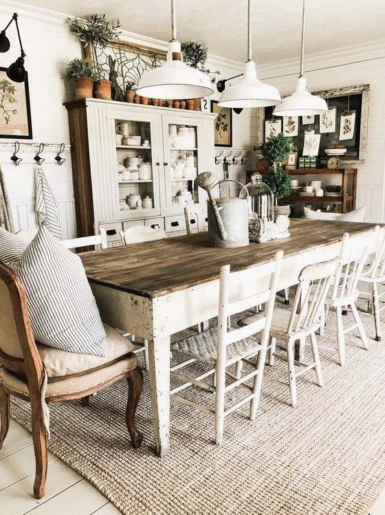 a welcoming farmhouse dining area with whitewashed furniture, upholstered chairs, white pendant lamps and a neutral buffet