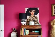 a whimsical magenta home office with a vintage wooden desk bureau, a leopard print chair, green storage units and bold art