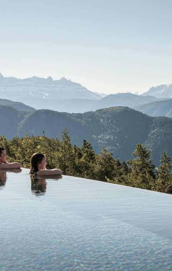 an infinity pool with a jaw-dropping mountain and tree view is the best place to spend a relaxing holiday in