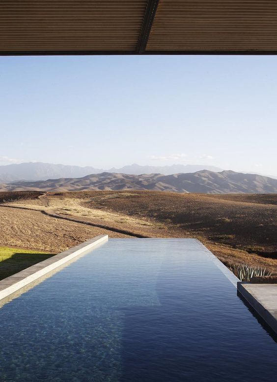 an infinity pool with a mountain and desert view is a lovely space to spend time and refresh yourself during a hot day