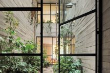 an inner townhouse courtyard with greenery and a stone floor is a great solution to add freshness here