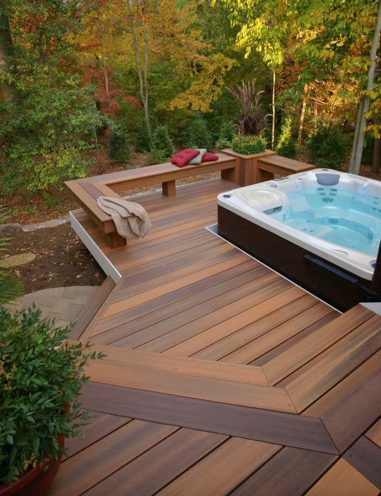an inviting hot tub sunk into a radius deck surrounded by forest is a perfect spot for maximum relaxation