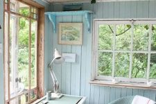 aqua and turquoise colored home office in a she shed looks cozy and cute