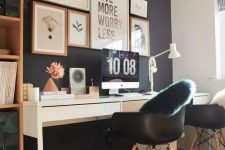 a Nordic home office with a black accent wall, a white shared desk, black chairs, a storage unit and a gallery wall