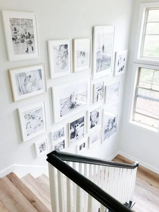 a beautiful free form gallery wall with white mismatching frames is a cool and chic idea and will add coziness