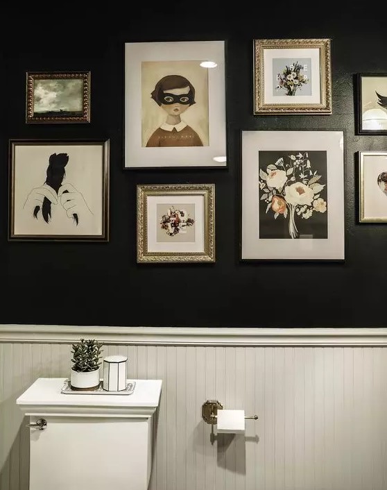 a black and white bathroom with wall paneling, white appliances and a catchy monochromatic gallery wall