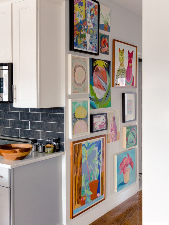 a blank wall filled in with super bold artwork all over is a lovely idea for a modern space, enjoy bold colors