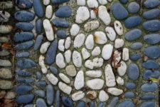 a blue pebble pathway with a white cat is a fun idea to add a personalizing touch to your garden