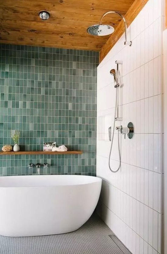 a bold contemproary bathroom with skinny white and mismatching green skinny tiles plus a grey mosaic tile floor
