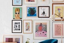a bright and colorful gallery wall with mismatching frames, colorful posters and artworks and fun primitive artworks