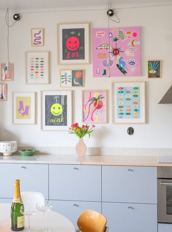 a bright and fun gallery wall with matching light stained frames and with no frames, with super bold artworks and posters