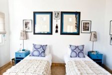 a bright double guest bedroom with a bright wallpaper ceiling, the prints of which match the pillows