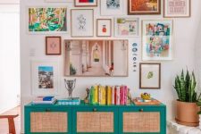 a bright gallery wall with mismatching frames and bold artworks, with a free form and a hanging with blue stones
