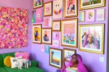 a bright living room with lilac walls, a colorful gallery wall with family pics and bright artwork and posters