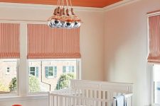 a bright orange ceiling, a matching chair and drawer to create a bold and welcoming kid’s room