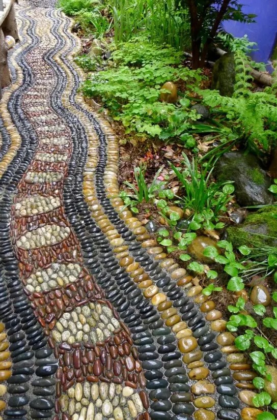 a bright pebble pathway in burgundy, yellow, black and neutrals with catchy patterns looks boho and relaxed