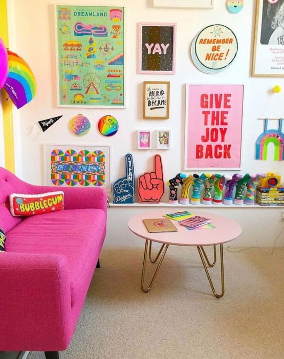 a bright pop art gallery wall with colorful artworks and posters plus bright decorative plates is a fun and chic idea with a bold look