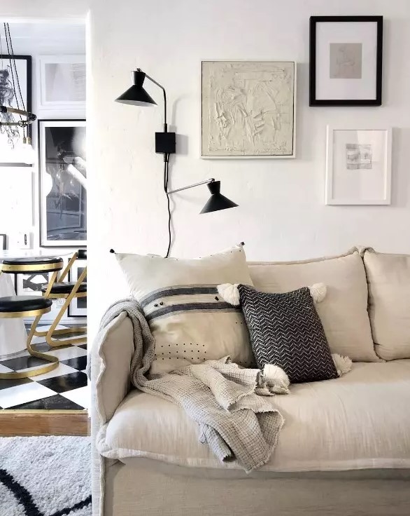 a chic neutral home accented with black touches and with a catchy 3 piece gallery wall that adds chic to the space