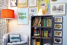 a colorful gallery wall with mismatching frames, a creative form, a gold bead monogram and some posters is fun