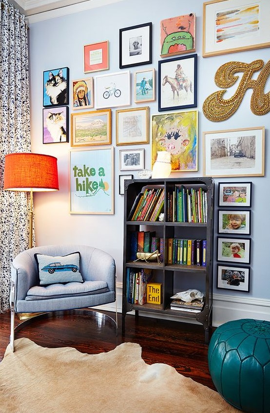 a colorful gallery wall with mismatching frames, a creative form, a gold bead monogram and some posters is fun