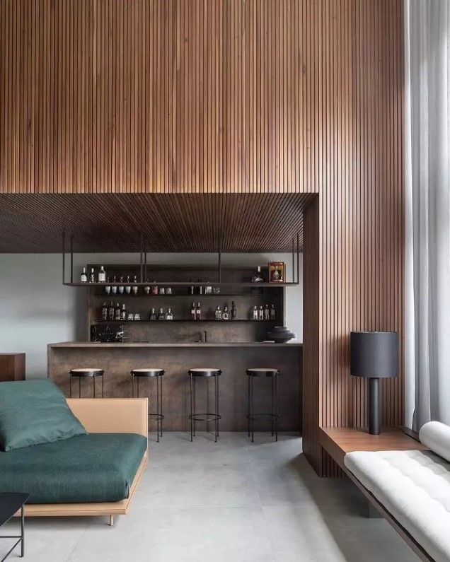 a contemporary home with a wood slat accent wall and a ceiling, a timber home bar and stylish contemporary seating furniture
