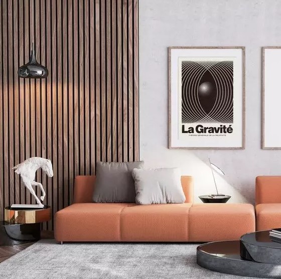 a contemporary living room with a wood slat accent wall, an orange sofa with neutral pillows and some elegant tables