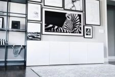 a fab black and white free form gallery wall with matching black frames and matting or no matting is a chic idea