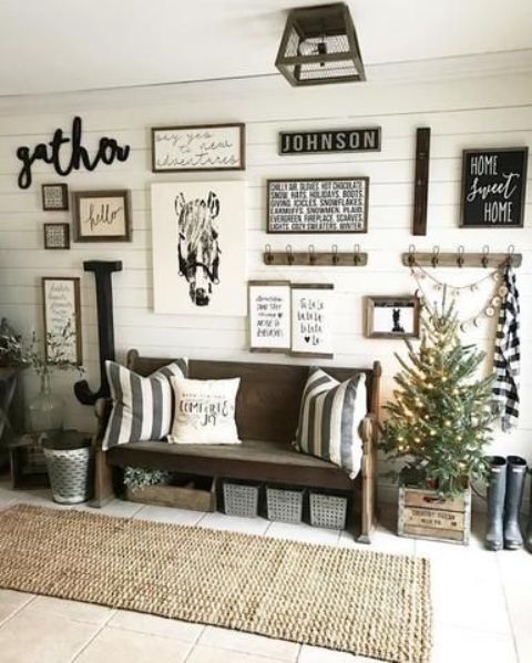 a farmhouse entryway gallery wall with art, signs, posters, artwork, calligraphy and some hooks and racks is great