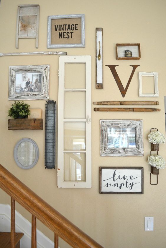 a farmhouse gallery wall with a window, some photos in frames, signs, potted greenery and various decor elements
