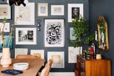 a free form gallery wall with framed and non-framed artworks, posters and prints plus some wall sconces is pure chic