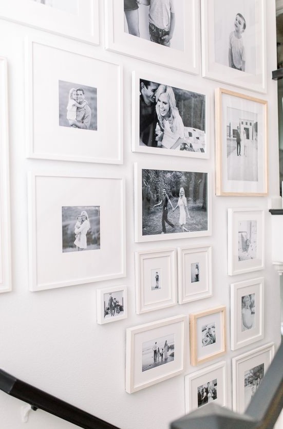 a free form gallery wall with mismatching frames, black and white photos is a stylish and chic idea with an eclectic feel