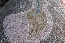 a gorgeous pebble pathway done with patterns in several colors – pink, blue and tan to add pattern and color to your space