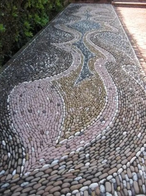 a gorgeous pebble pathway done with patterns in several colors   pink, blue and tan to add pattern and color to your space