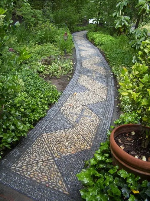 a grey and neutral pebble gardne path with a geometric pattern is a stylish idea that will add a modern feel to the outdoor space