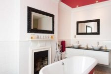 a hot red ceiling and an echoing bathtub make the space bold and add personality to it at once