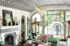 a jaw-dropping living room with a graphic wallpaper arched ceiling, the pattern of which echoes with the furniture below