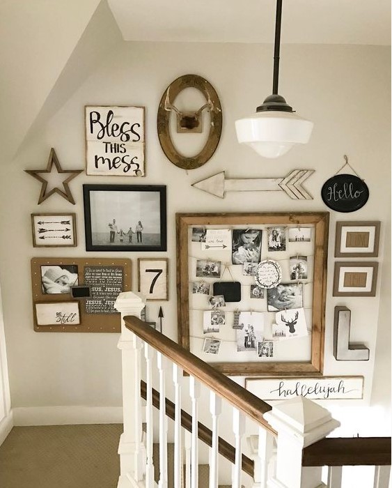a large rustic gallery wall with family pics in frames, a memo board with photos and monograms, arrows and letters is cool